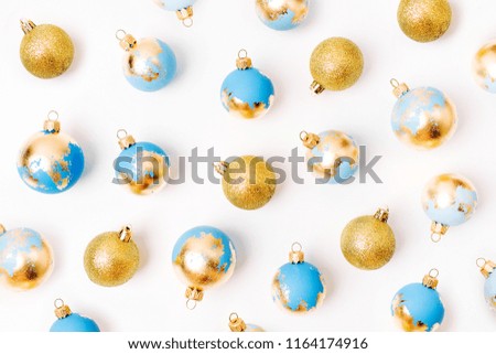 Christmas composition made of blue  Christmas balls with gold leaf on white background. Flat lay, top view