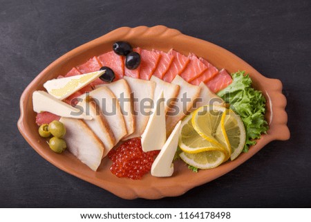 Assorted fish on a plate. Cold snack