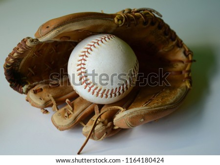 full Baseball glove and baseball laying in the pocket
