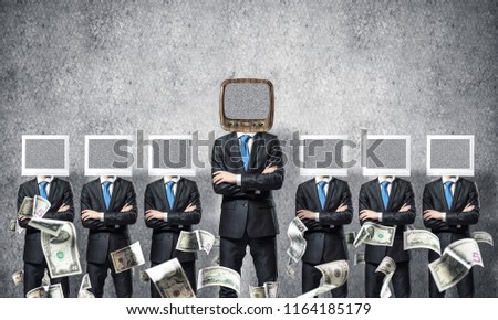 Businessmen in suits with monitors instead of their heads keeping arms crossed while standing in a row and one at the head with old TV in empty room against gray wall on background.