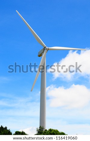 A wind turbine in the sunshine on blue sky background, Thailand.