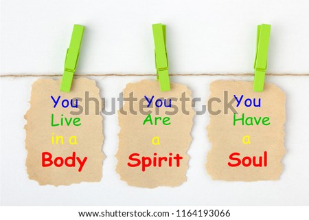 Body Spirit Soul written on old torn paper with clip hanging on white background.
 Royalty-Free Stock Photo #1164193066