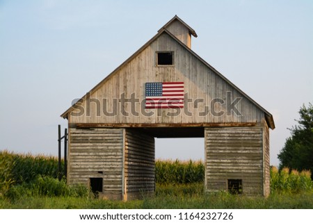 Old rustic barn in the Midwest with painted American flag.  LaSalle, Illinois, USA