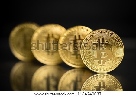 Row of bitcoins in physical form with black background