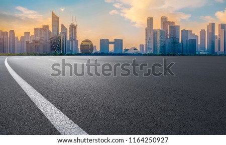 Urban road asphalt pavement and skyline of Hangzhou architectura