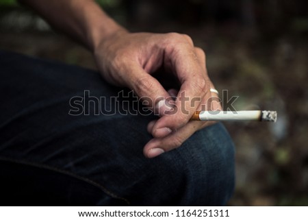 young man smoking cigarette.concept for breaking and quite cigarette for healthy.background empty space for text.
