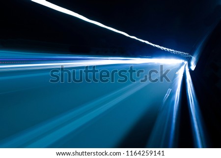 Art images. Abstract effect. The wild light from the car lights and street lights enters the camera lens along the highway at night