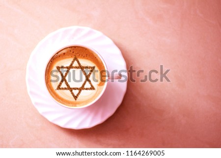 a cup of coffee in Israel cappuccino with a picture of the star of David