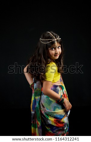 Little baby girl, dressed in a Sari of Indian culture. Traditional Indian attire.