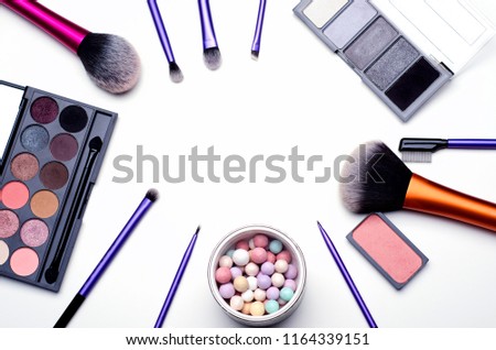 Make-up kit frame made with brushes, face cream, eyshadow and blusher Royalty-Free Stock Photo #1164339151