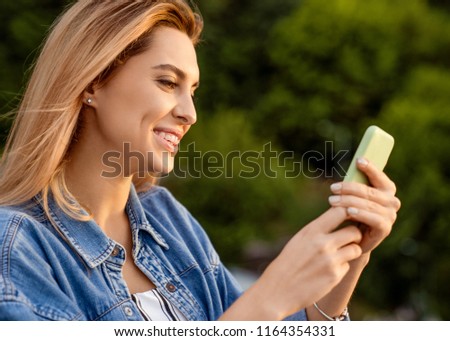 beautiful fashion girl doing selfie with phone at sunset