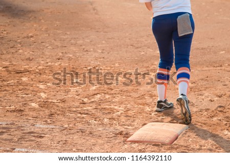 Player stand on home plate in a baseball (softball) dusty field, with copyspace