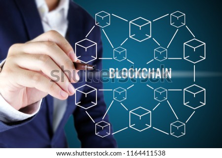 Businessman pointing at blockchain concept.Blockchain technology concept with cube and line connected.
