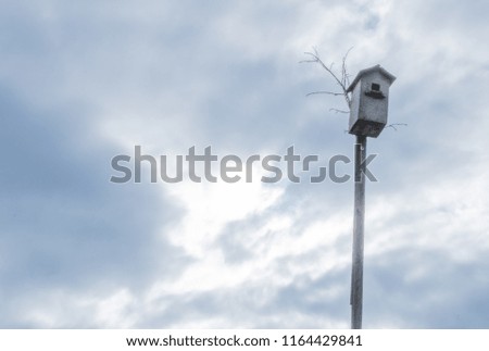 Village. Rural. The sky before the rain. The birdhouse on the background of the cloudy sky.