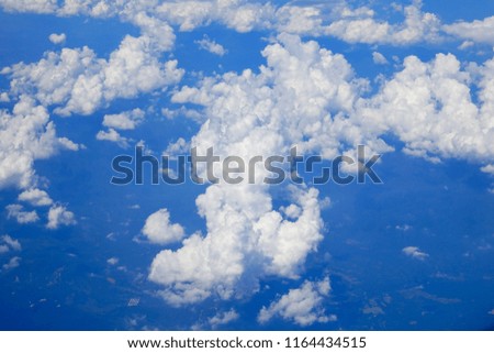 Blue sky and white clouds background,view from the window of an airplane flying.