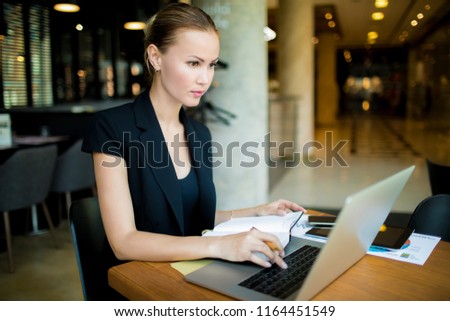 Woman marketer searching information on stock training via laptop computer. Female professional business analyst working on portable net-book. Women CEO using applications on notebook device 