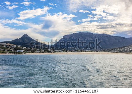View from the Hout Bay (Houtbaai, meaning as "Wood Bay") to the Hout Bay village and the mountains. Hout Bay - suburb of Cape Town in South Africa.
