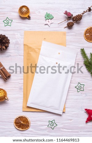 Postal packaging, bubble envelopes on wooden background, Christmas