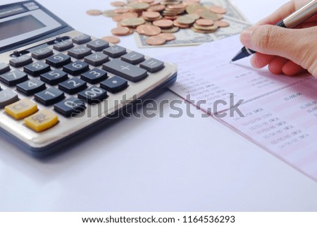 table at home with calculator,data bank   and money  on isolated white background.business finance saving planning  account concept. 