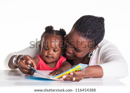 Mother is showing some pictures in a book to her daughter.