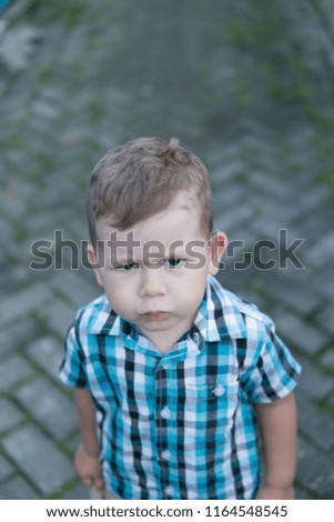 Angry little boy do not want to sit for a picture