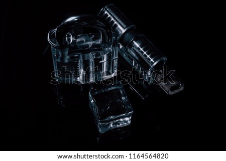 locks and ice cube on black background
