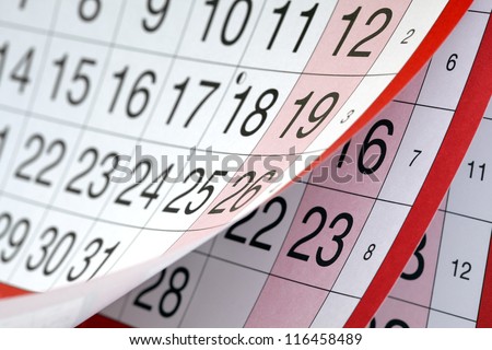 Months and dates shown on a calendar whilst turning the pages Royalty-Free Stock Photo #116458489