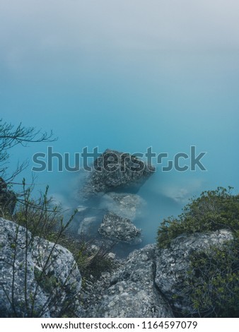 
Lake Sorapiss in the fog with amazing turquoise color of water. The mountain lake in the Dolomites. Italy