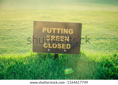 Putting Green Closed golf course sign on a summer evening