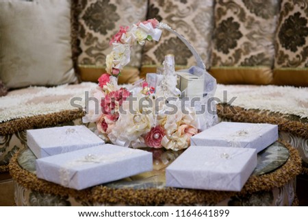 A decorative ribbon trims the basket which contains gifts and surprises.