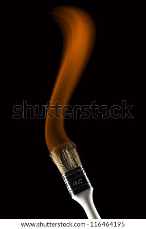 Burning paintbrush on black background painting with fire