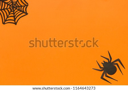 Halloween background. Black paper spider and spiderweb on orange background Happy halloween concept, space for text. Top view. Mockup, Layout Flat lay