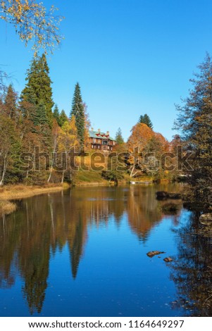 Manor house a hill by the river in autumn landscape