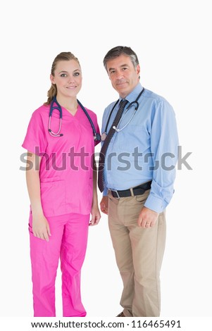 Two smiling doctors with one wearing pink scrubs