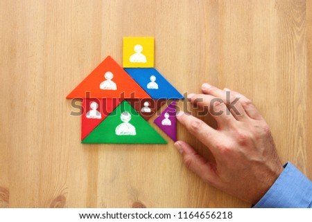 image of tangram puzzle blocks with people icons over wooden table ,human resources and management concept