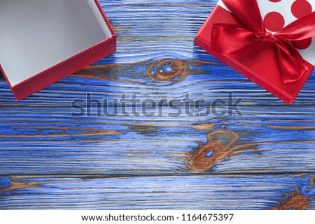 Opened gift box on vintage wooden board.