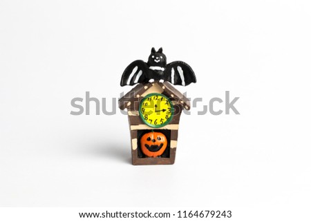 Halloween brown house with a pumpkin, yellow watch, and black bat at roof on a white background.
