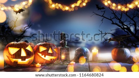 Spooky halloween pumpkins on wooden planks with dark horror background. Celebration theme, copyspace for text.