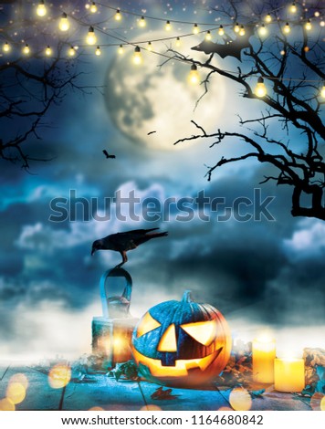 Spooky halloween pumpkin on wooden planks with dark horror background. Celebration theme, copyspace for text.