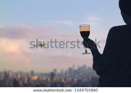Female hand with glass of wine on Manhattan background. New York city.  Service on the roof of the restaurant                       