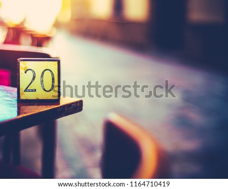Retro Detail Of A Table Number At A Paris Cafe In An Empty Street At Sunset With Copy Space