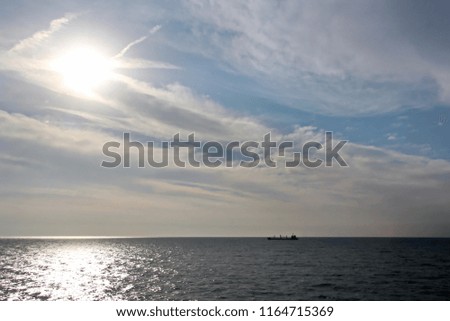 Seascapes. Various kinds of colorful blue sky, sun, clouds and open spaces of the world ocean. View from the side of a sea ship while moving and in the port at anchor.
