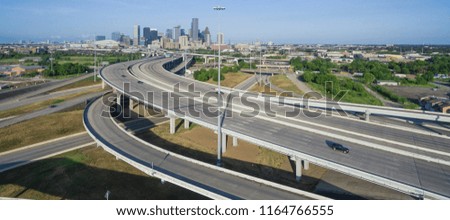 Panorama aerial view Houston downtown and interstate 69 highway with massive intersection, stack interchange and elevated road junction overpass at early morning from the northeast side of Houston, US