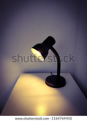 minimalist decor, black light on white table