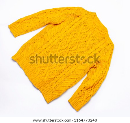 Female orange knitted sweater on white background top view flat lay. Fashion Lady Clothes Set Trendy Cozy Knit Jumper Autumn accessories. Female fashion look Royalty-Free Stock Photo #1164773248