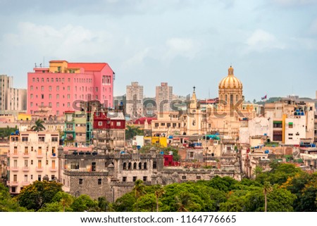 dilapidated stone buildings of an ancient city with a dome of the Capitol on a blue background of a clear tropical sky