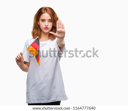 Young beautiful woman holding flag of germany over isolated background with open hand doing stop sign with serious and confident expression, defense gesture