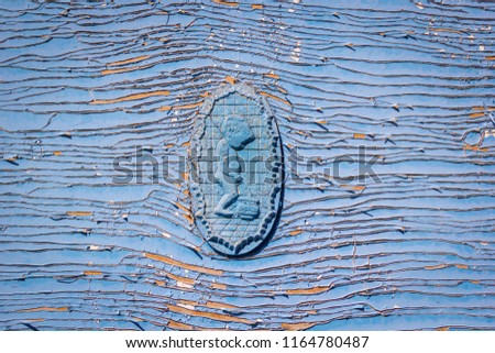Symbol pissing boy, Restroom sign on WC / Toilet door on old weathered wooden plank painted in blue color, wooden texture wall background