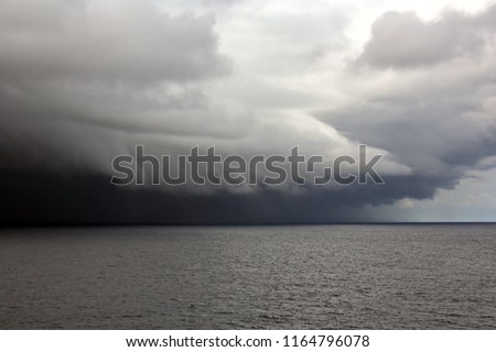 Before the storm. A painted view of storm and rain clouds and the sky above the sea horizon. View from the side of a sea ship while driving and in the port at anchor.