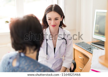 The young smiling breast specialist talking with the patient in her office Royalty-Free Stock Photo #1164825466